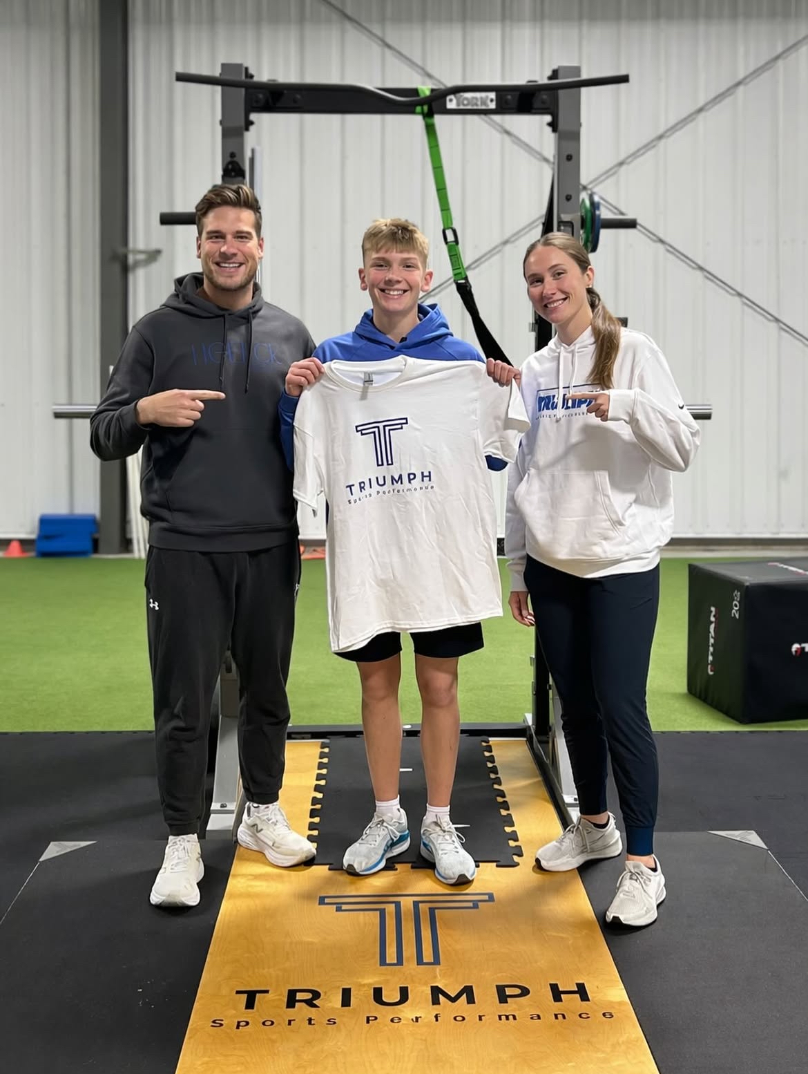 Athlete celebrating progress with Triumph coaches