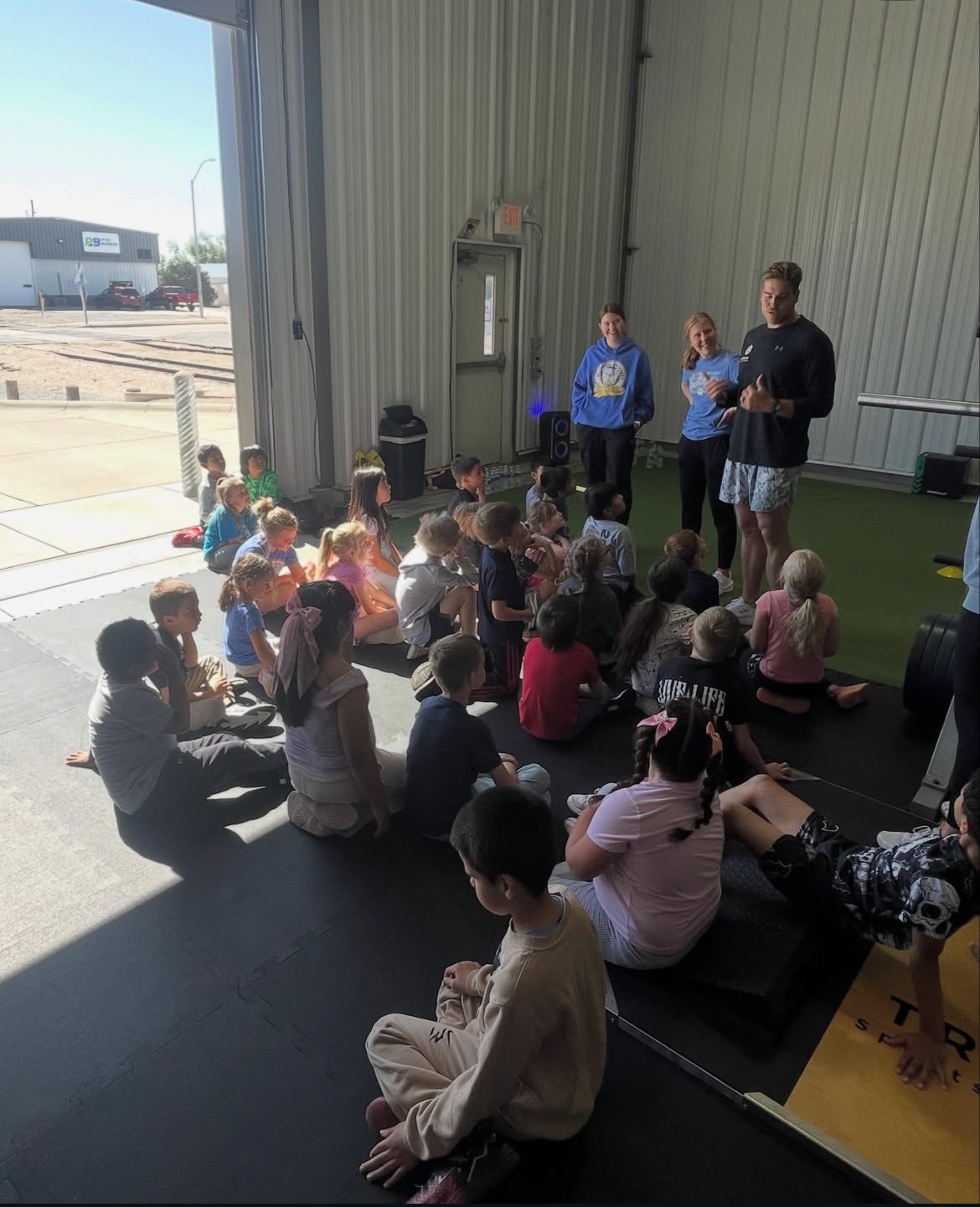Youth athletes learning together inside Triumph