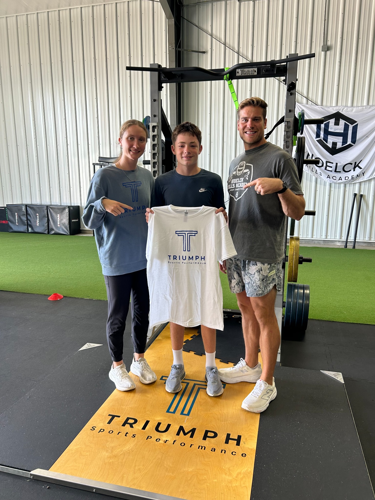 Cash, Triumph Sports Performance September Athlete of the Month, with coaches Meg Burns and Corey Hoelck