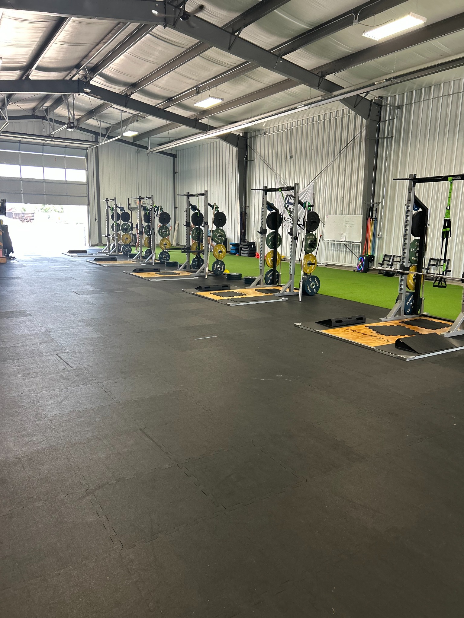 Triumph training floor with strength racks and turf